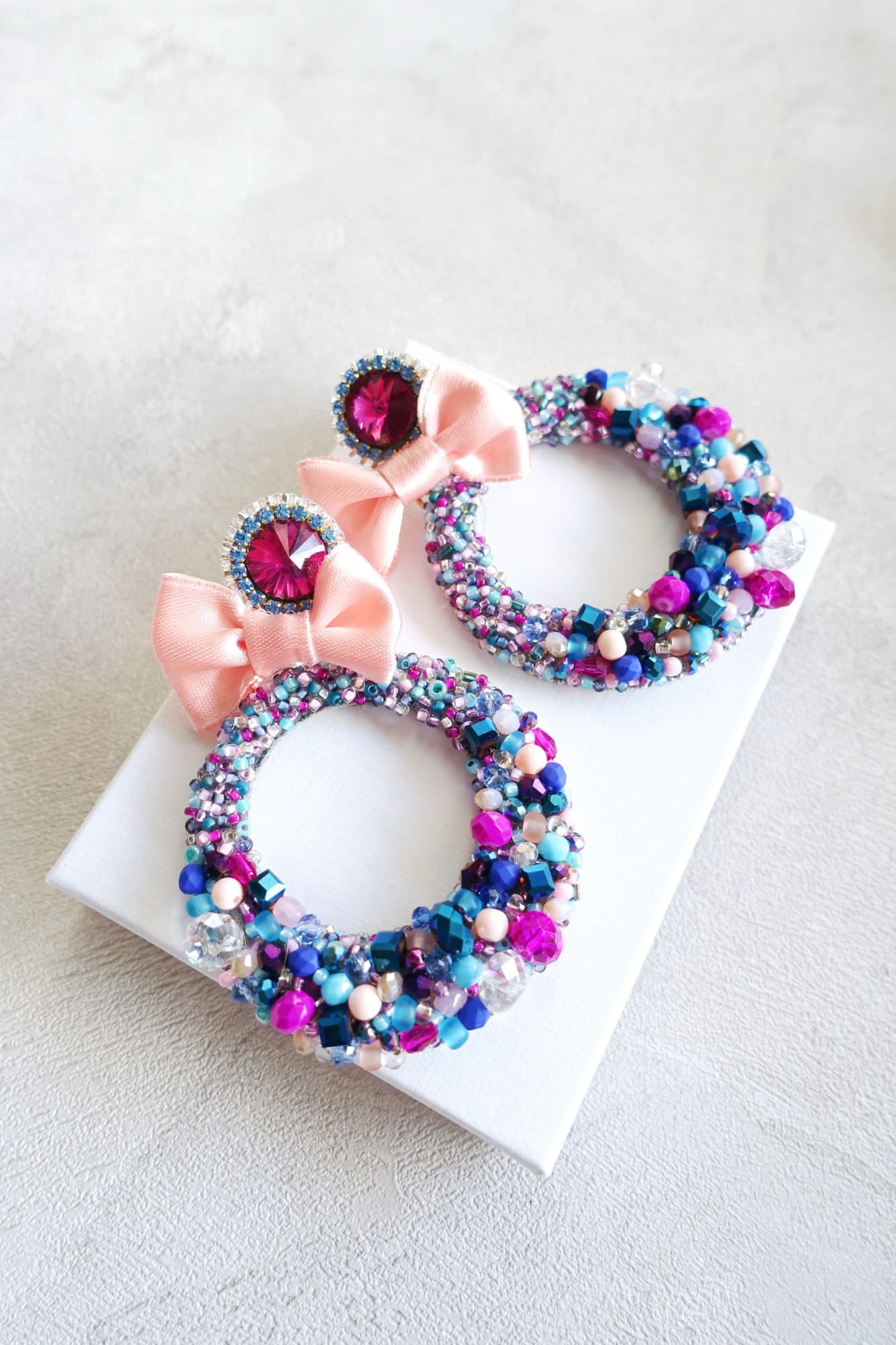 Colorful earrings with crystals on a hoop with a bow 505 Candy