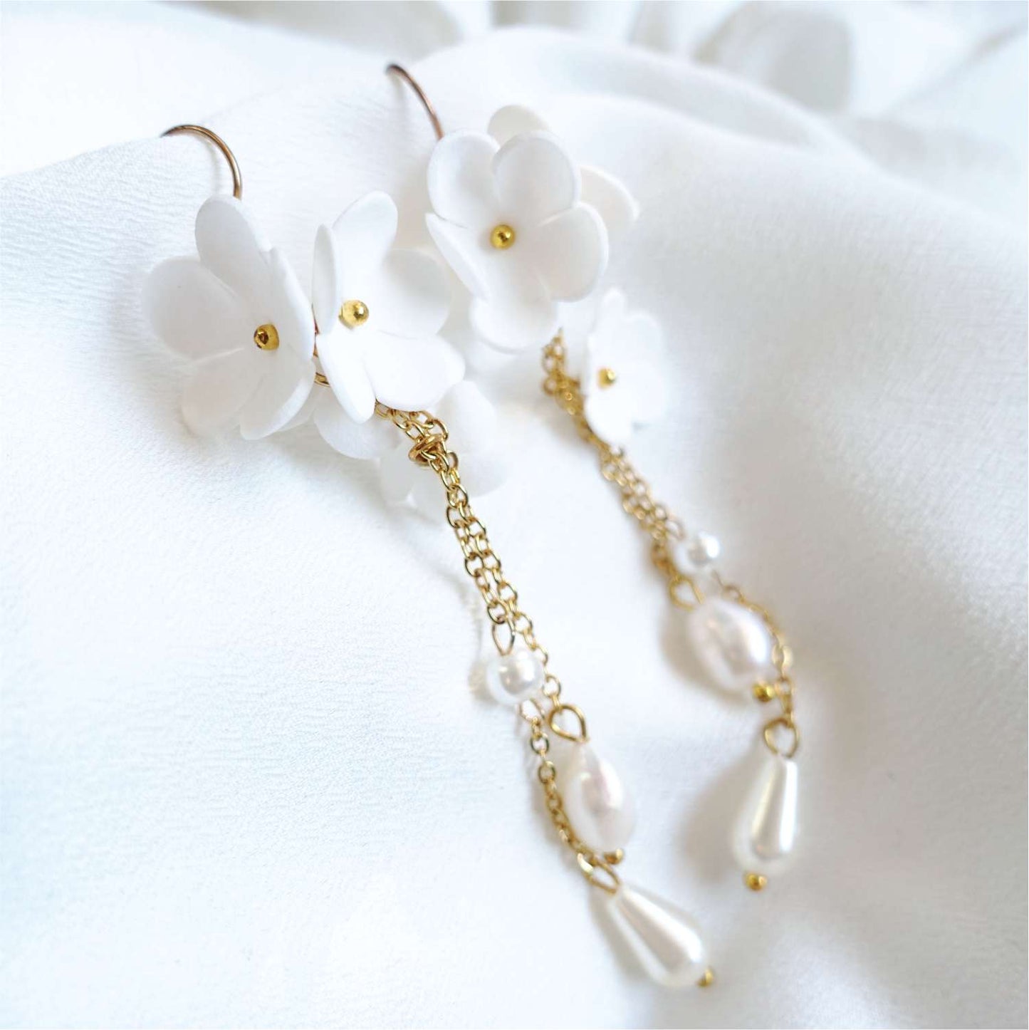White Daisy DK850 small flower earrings on a gold chain